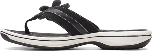 A black sandal with a flower on the upper.