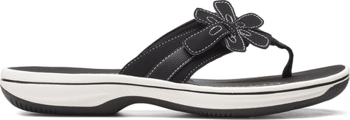 A women's black sandal with a flower on the strap.
