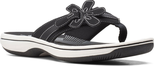 A black sandal with a flower.