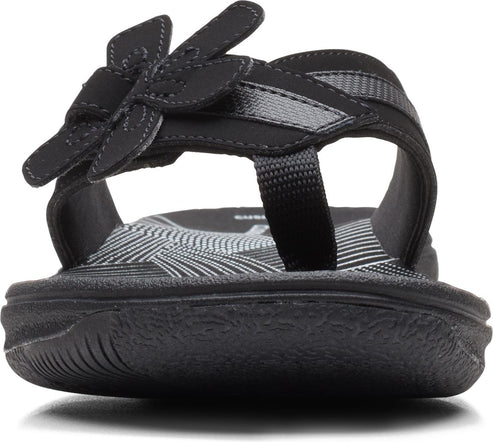 Black sandal with flower detail on strap.