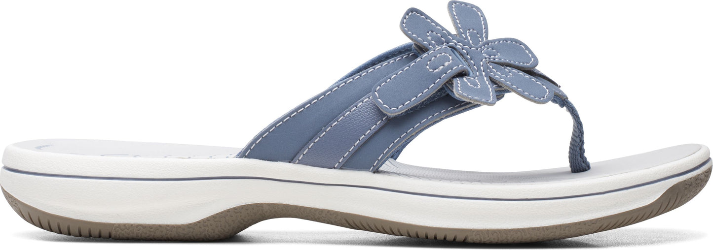 A blue sandal with a flower.