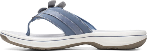 A blue sandal with a flower on top.