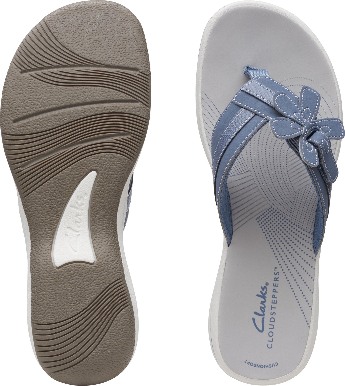 Light blue flip flops showing the textured sole and the insole featuring a flower design.