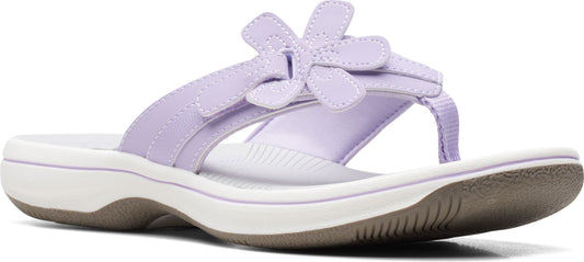 Lavender sandal with flower detail on the straps and a white sole.