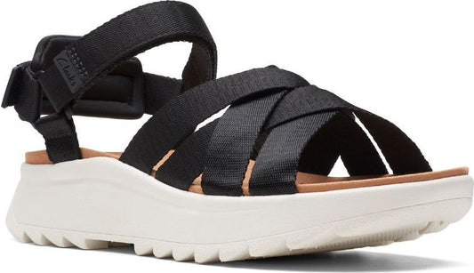 Black sport sandal with velcro ankle strap, woven straps across the foot, light-colored platform sole.