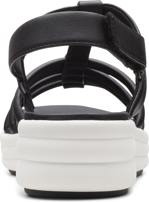 Back of a black sandal with horizontal straps and a white platform sole.