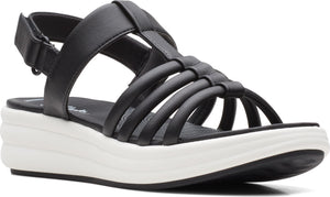 Black platform sandal with straps and adjustable velcro closure.