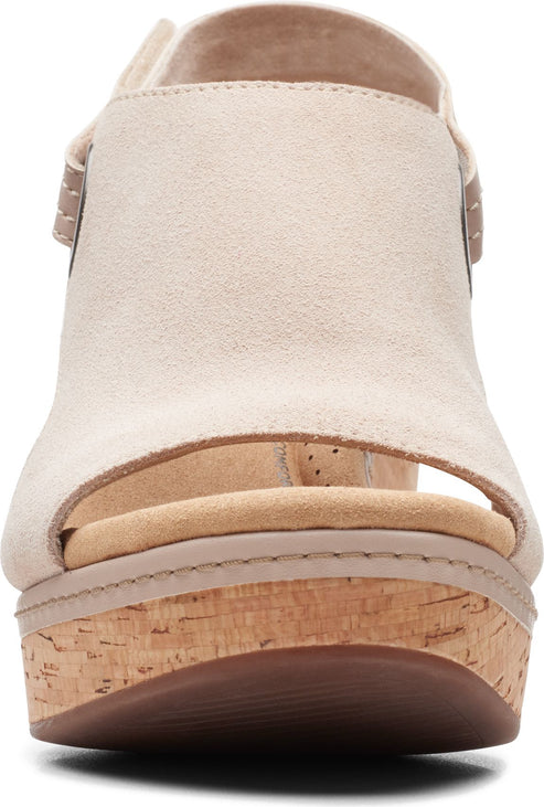 Beige suede wedge heel sandal with an open toe and a cork platform.
