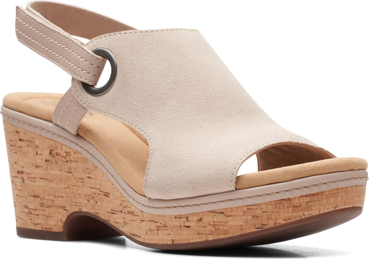 Beige suede wedge sandal with cork heel and adjustable ankle strap.