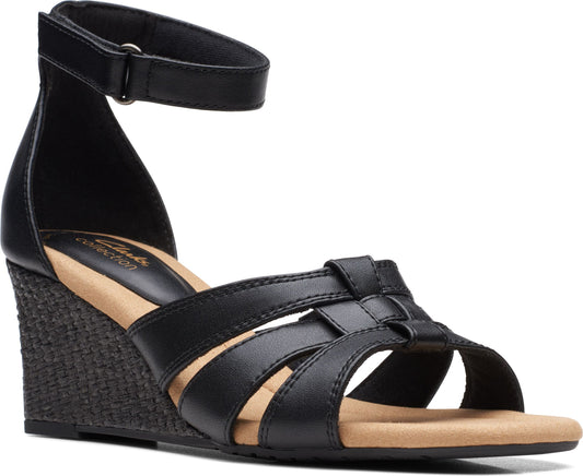 Black wedge sandal with ankle strap and interwoven straps over toes.
