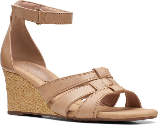 Beige wedge sandal with woven straps and ankle strap.