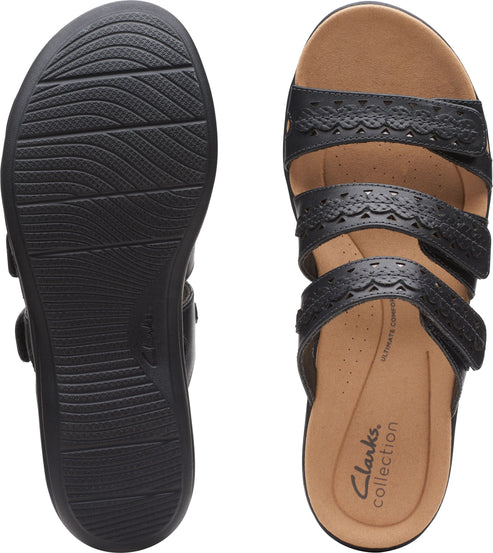 Two black sandals: one shows the bottom which is ridged for traction; the other shows the upper with three straps of decorative punched-hole leather, a brown insole, and the text "Clarks collection ULTIMATE COMFORT".