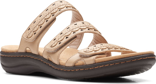 Tan sandals with hook and loop straps and decorative cut-outs.