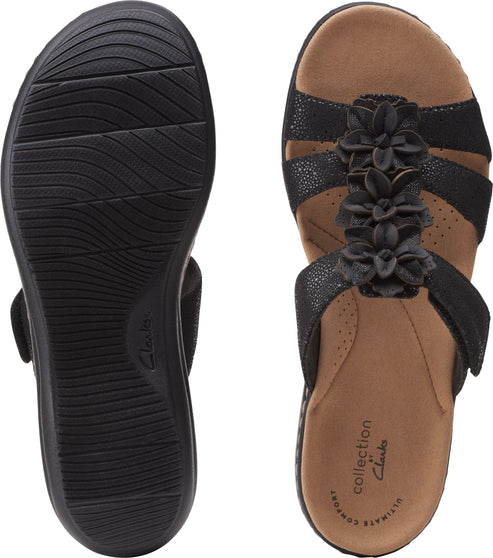 Black sandal with floral embellishments, adjustable straps, and patterned sole.