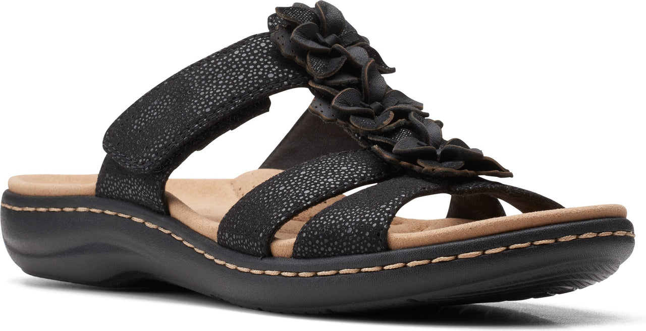 Black sandal with adjustable hook-and-loop strap and flower embellishment.