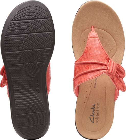 A pair of coral colored flip-flops with a tied detail, one showing the sole and the other showing the insole with "Clarks Collection" text.