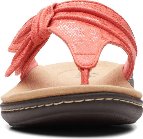 Front view of a coral sandal with thong strap and knot detail on top.