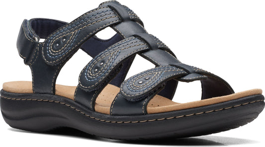 Navy blue leather sandal with a closed toe, flat heel, adjustable velcro straps, and decorative stitching.