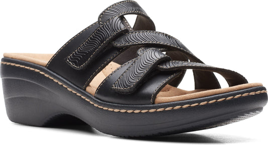 Black leather wedge sandal with velcro straps and patterned detailing.