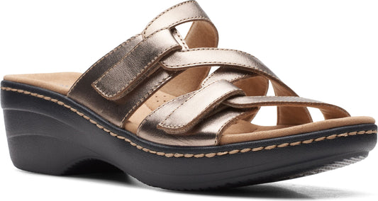 Metallic gold sandal with three velcro straps on top of a low black wedge sole.