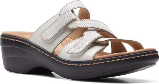 White leather-like wedge sandal with three hook and loop adjustable straps.