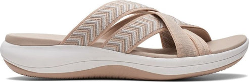 Slip-on sandals with crisscrossing straps and a thick sole.