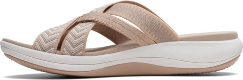 A cross-strapped beige slide sandal with a white sole.
