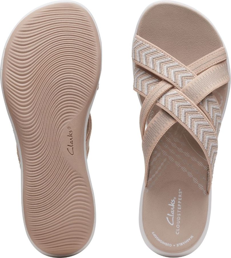 Pair of criss-cross slip-on sandals: one showing the tan rubber sole with white trim and wave pattern, the other showing crossed beige straps with white and brown geometric pattern.