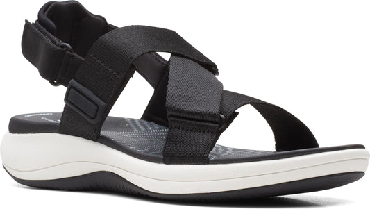 Black sandal with cross-straps and a white curved sole.