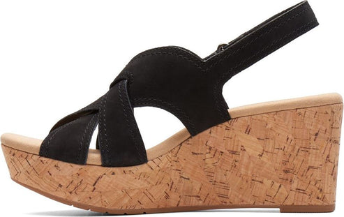 A black criss-cross strap wedge sandal with cork platform heel.