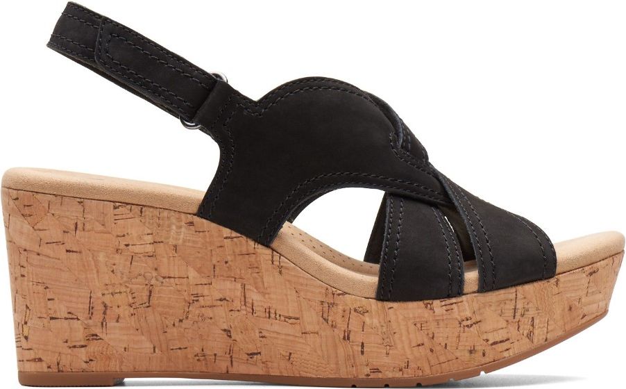 A black sandal with a wedge cork heel and slingback ankle strap.
