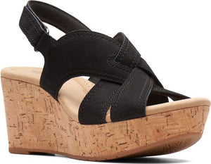 Black wedge sandal with criss-cross straps and cork platform.