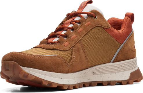 A brown suede and canvas hiking shoe with orange laces and speckled white midsole.