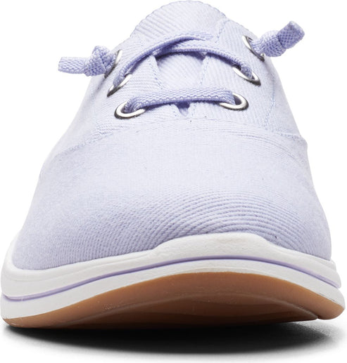 Close-up of a lavender boat shoe with a white sole and brown gum sole.