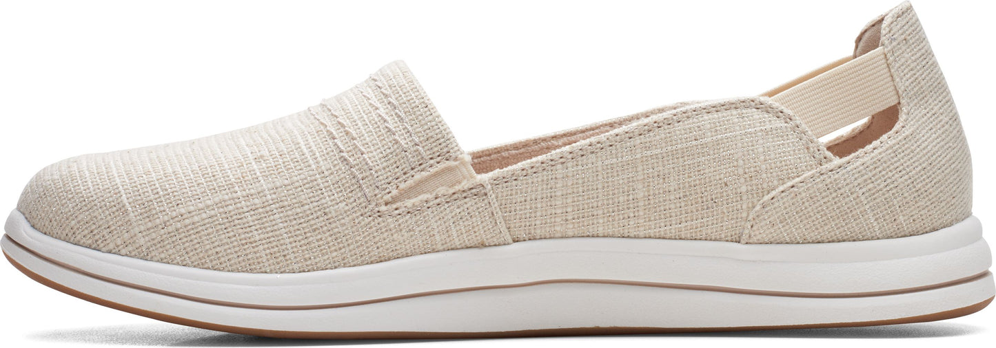 A flax-colored slip-on shoe featuring a white sole.