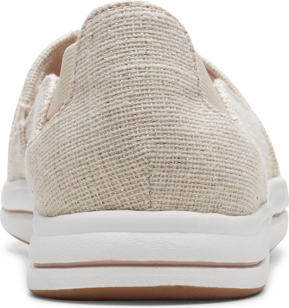 Close-up of a beige slip-on shoe with a white sole and a brown outsole.