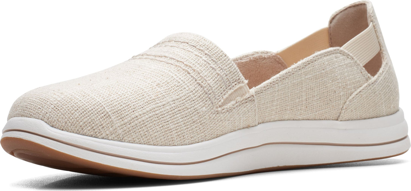 A beige slip-on shoe with a white sole and brown trim.