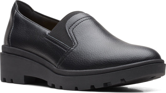 Black slip-on shoe with a lug sole platform.