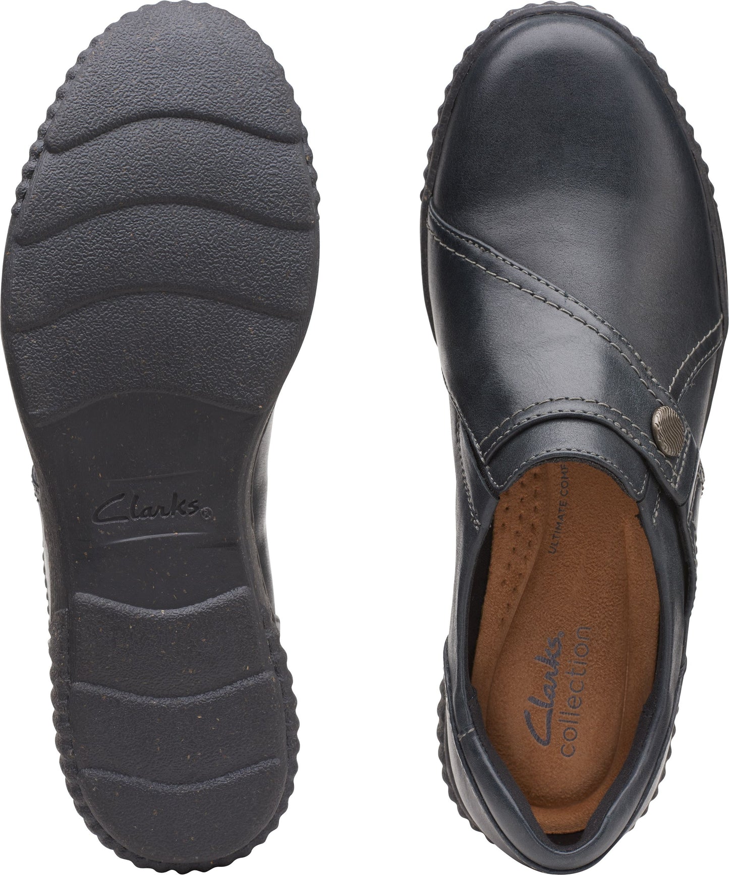 Black leather clog with an asymmetrical seam and a decorative button, view of the textured sole.