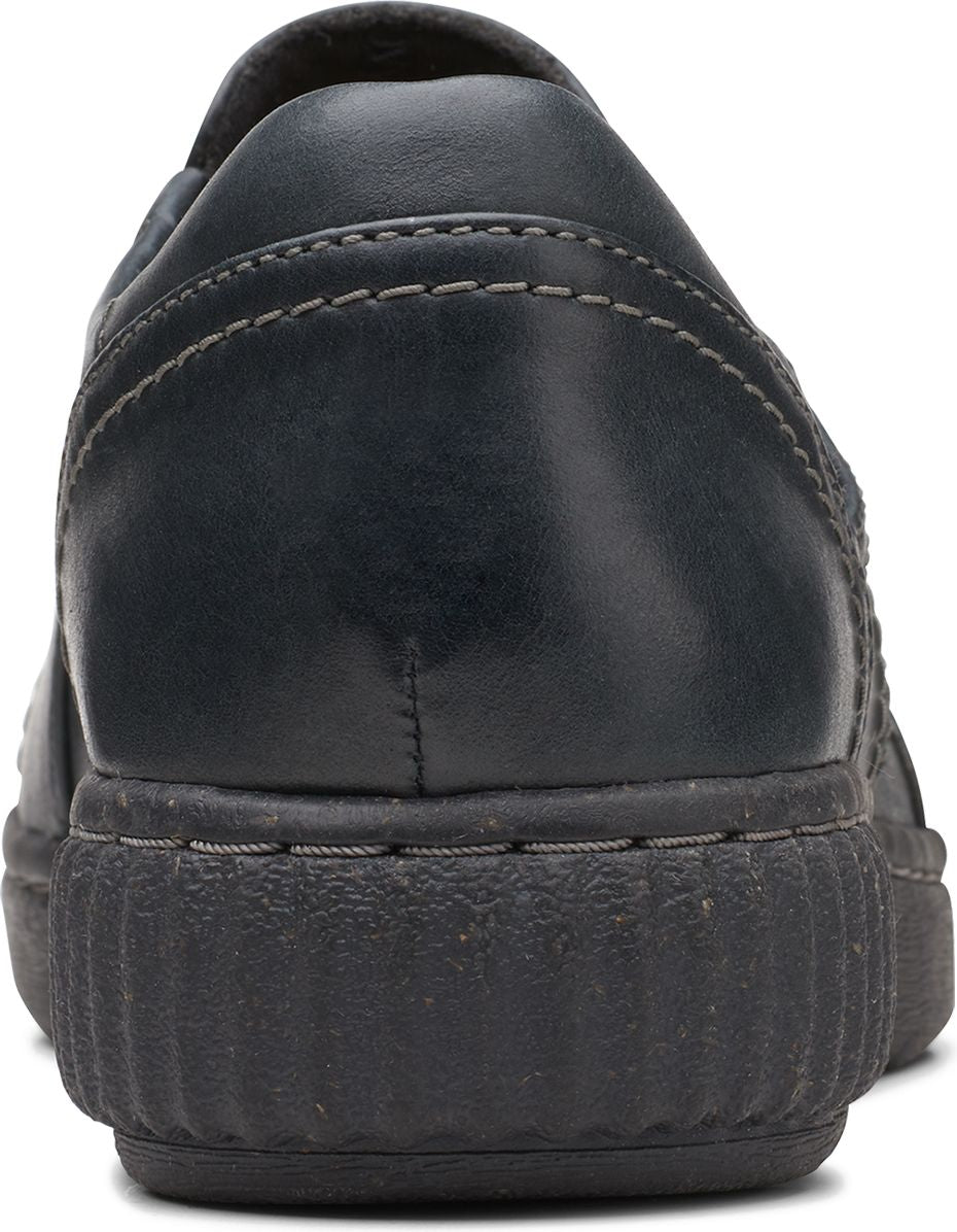 Back of a black leather slip-on shoe with a rubber sole.