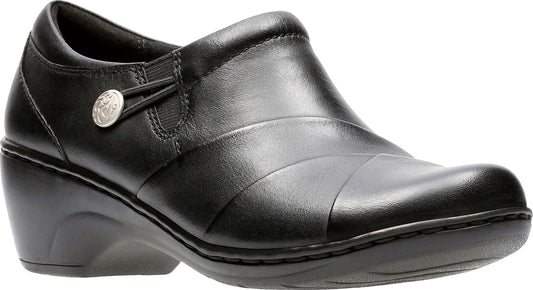 Black leather clog with a rounded toe, low wedge heel, and decorative button detail.
