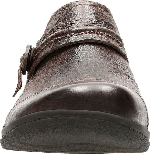 Brown leather slip-on shoe with decorative buckle strap.