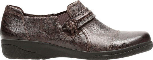 A bronze-colored loafer with a decorative strap and knotted button detail.