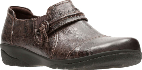 A brown leather shoe with a buckle-like strap.