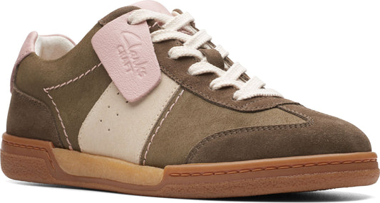Olive green and beige suede sneaker with a gum sole and light pink details, bearing a tag with 'Clarks Craft' text.