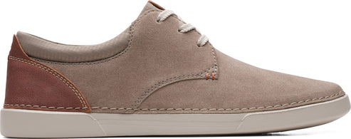 A neutral-toned leather shoe with matching laces and a contrasting brown heel.