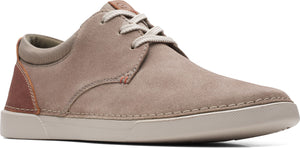 A taupe suede shoe with white laces and a light sole.