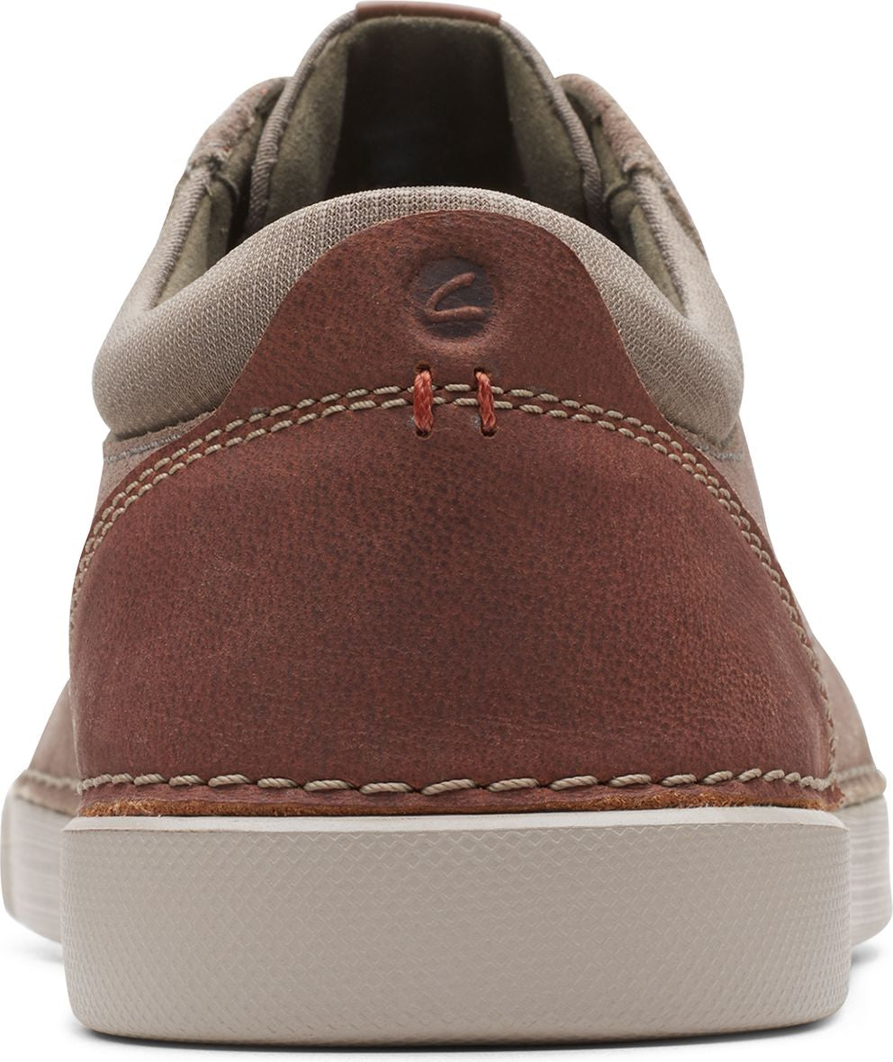 Back of low-top tan and brown leather sneakers.
