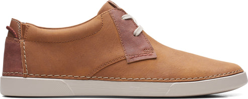 A tan leather shoe with white soles and white laces.