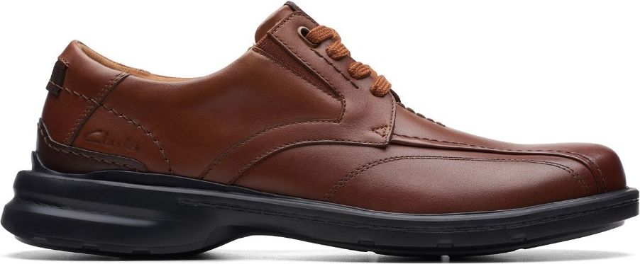 A brown leather dress shoe with a black sole.